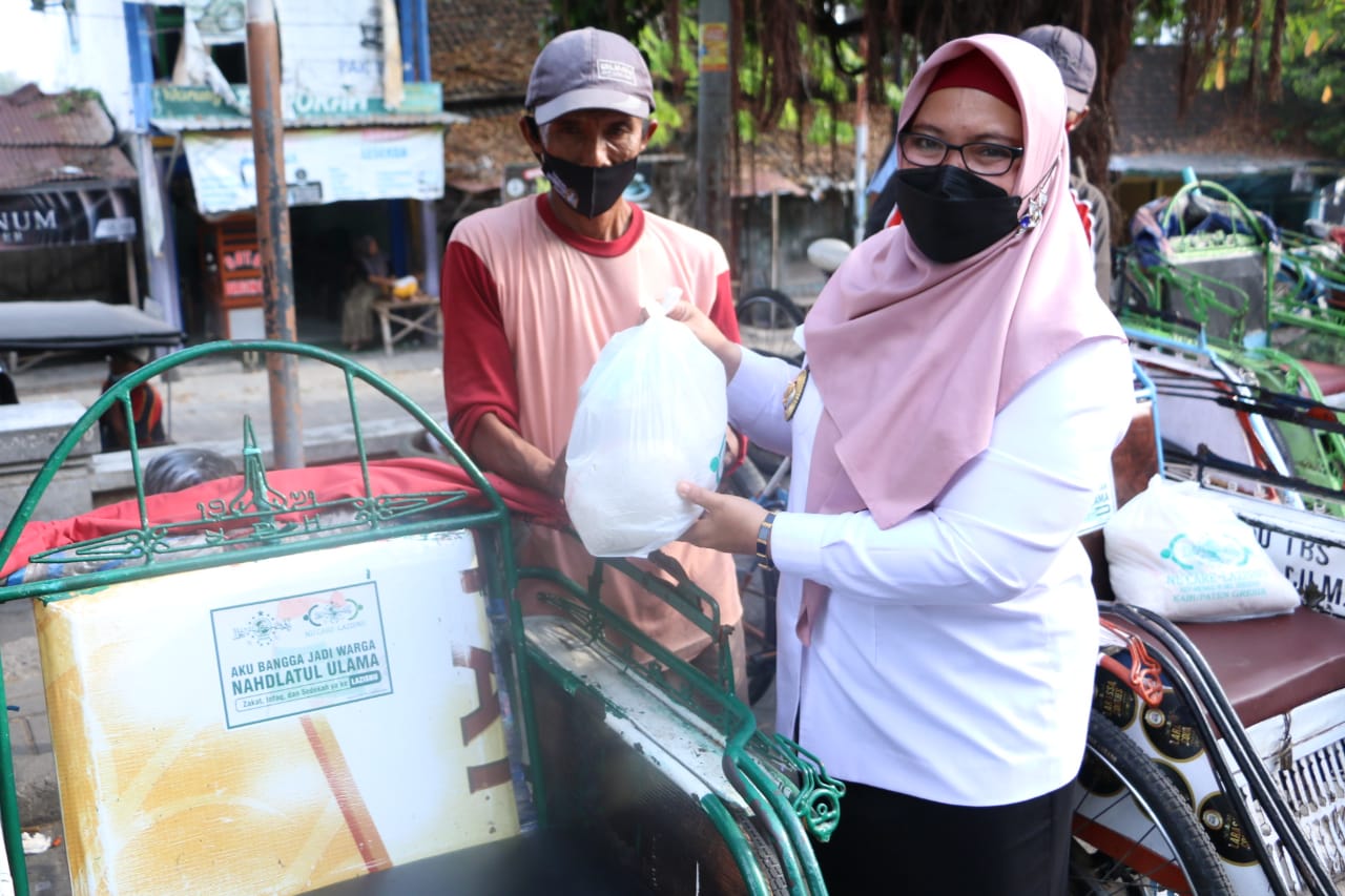 Wabup Gresik Aminatun Habibah membagikan sembako kepada para pekerja di sekitar makam Sunan Giri, Rabu (18/8/2021).